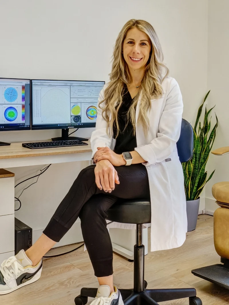 Dr. Ariel Cerenzie evaluating corneal elevation topography and axial length measurements for pediatric myopia control