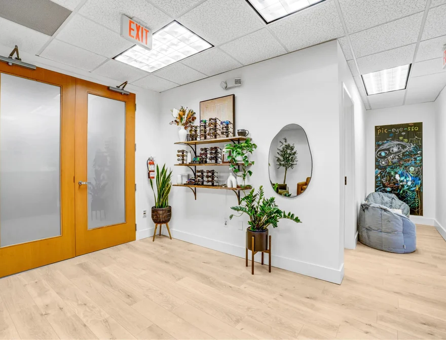 Office entry, custom eyewear display, and clinic reception hallway