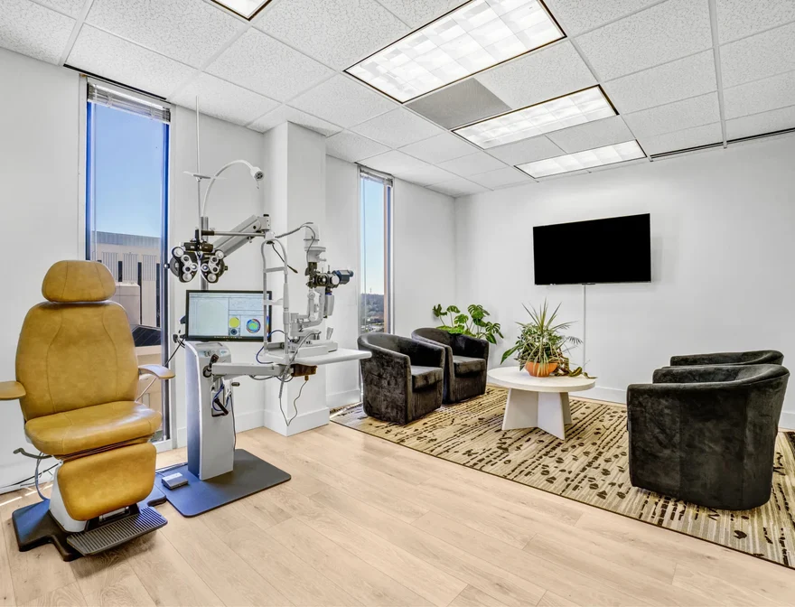 Spacious examination suite with patient seating and diagnostic equipment
