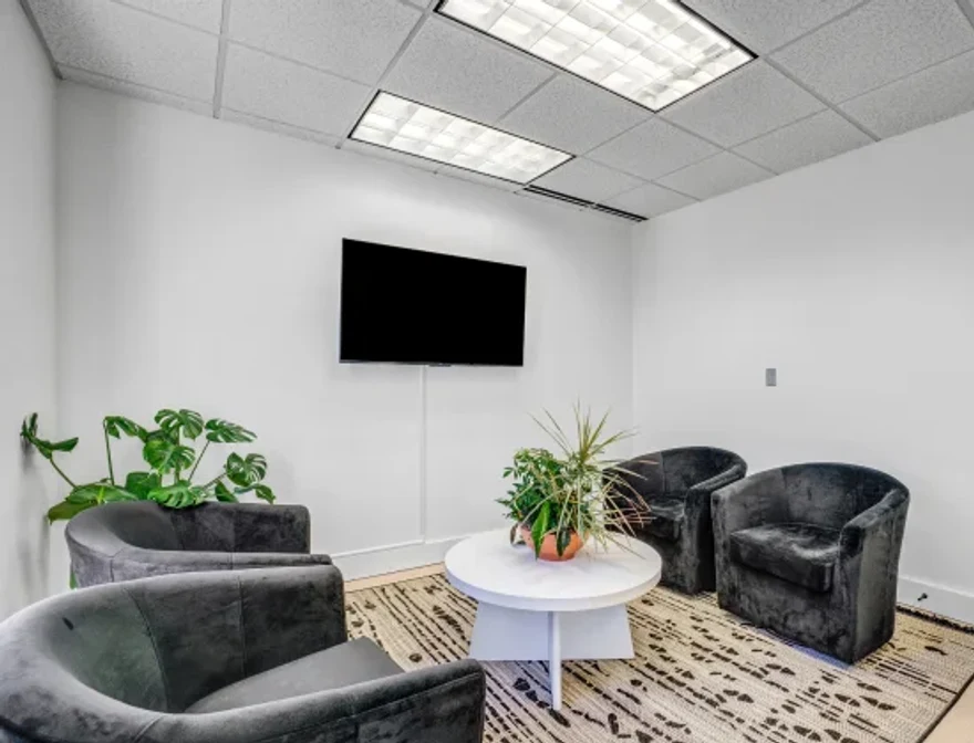 Comfortable patient lounge with plush seating and warm lighting