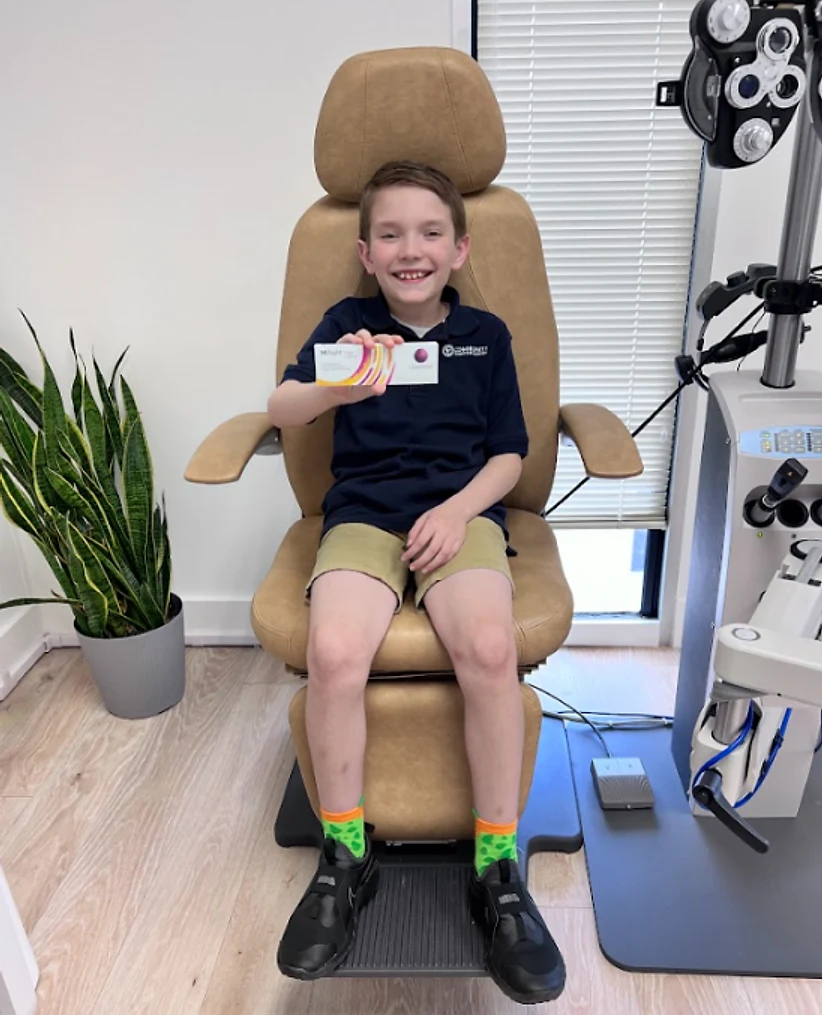 Pediatric patient undergoing anterior segment slit lamp evaluation for MiSight lenses