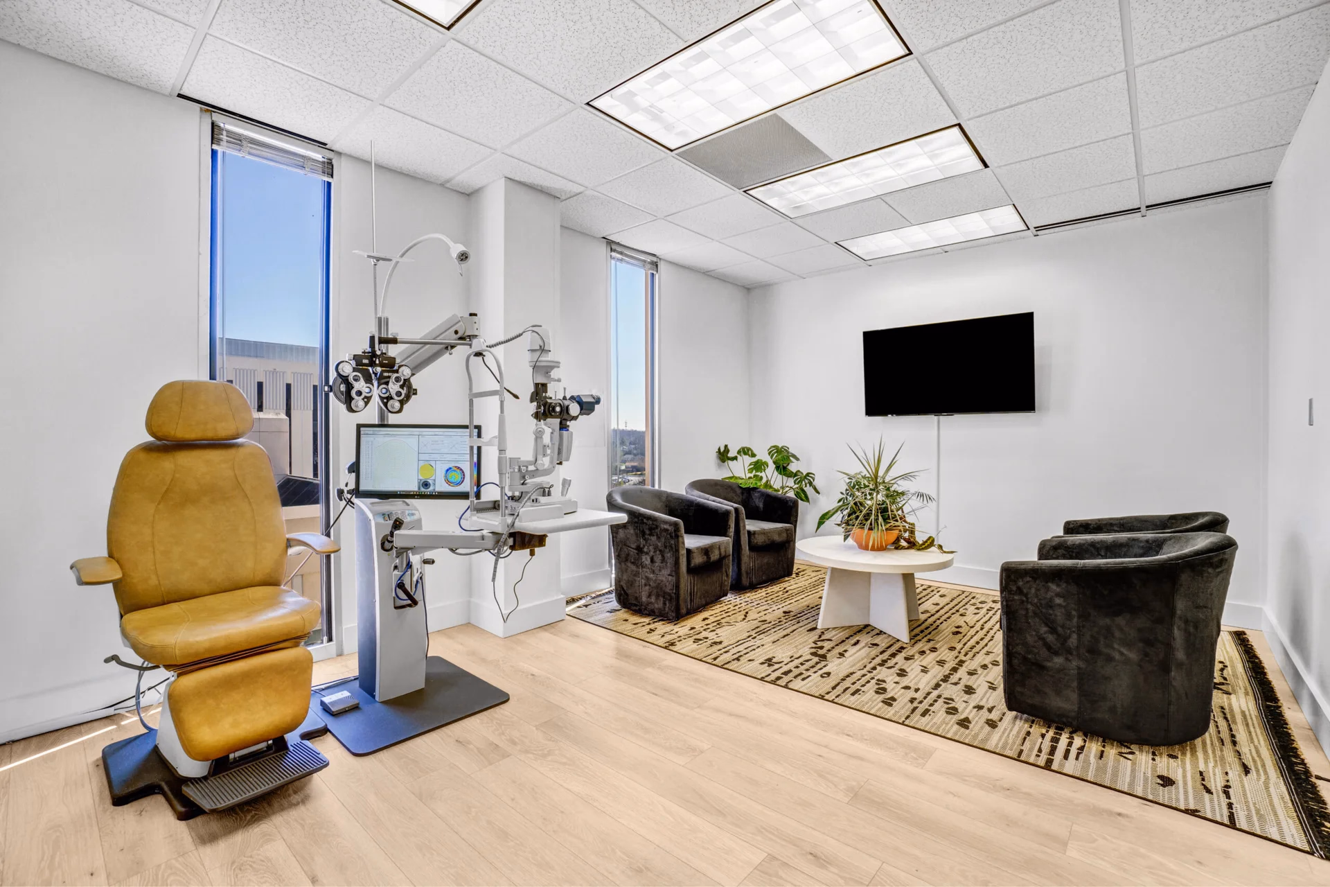Comfortable lounge chairs and a coffee table in the patient seating area