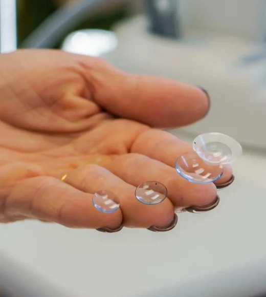 Specialty contact lenses resting on fingertips